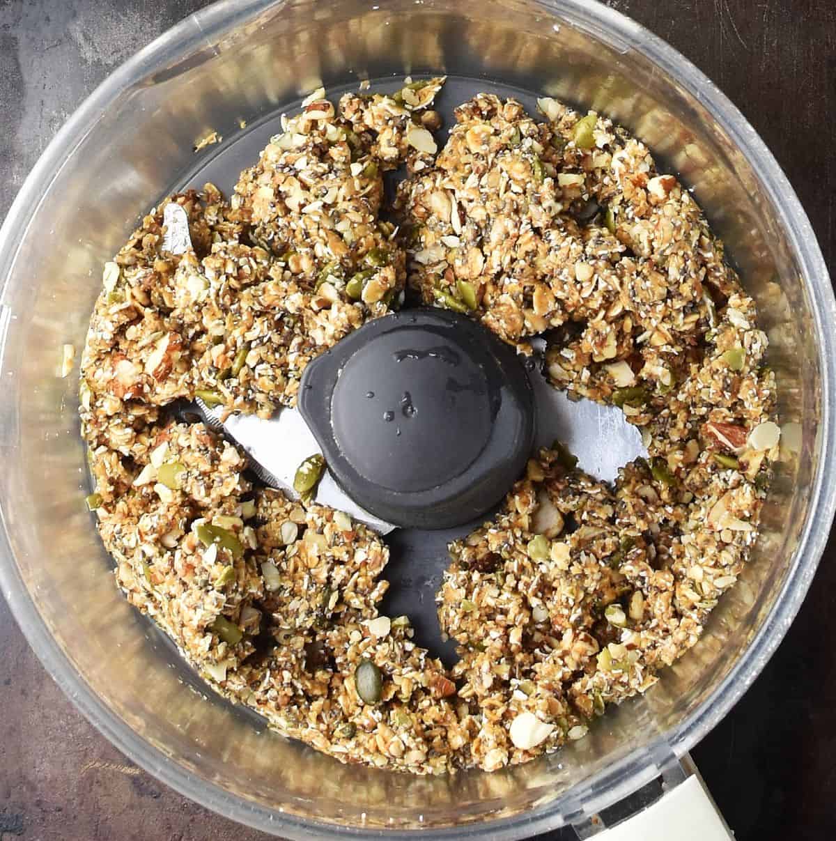 Granola bar mixture in food processor bowl.