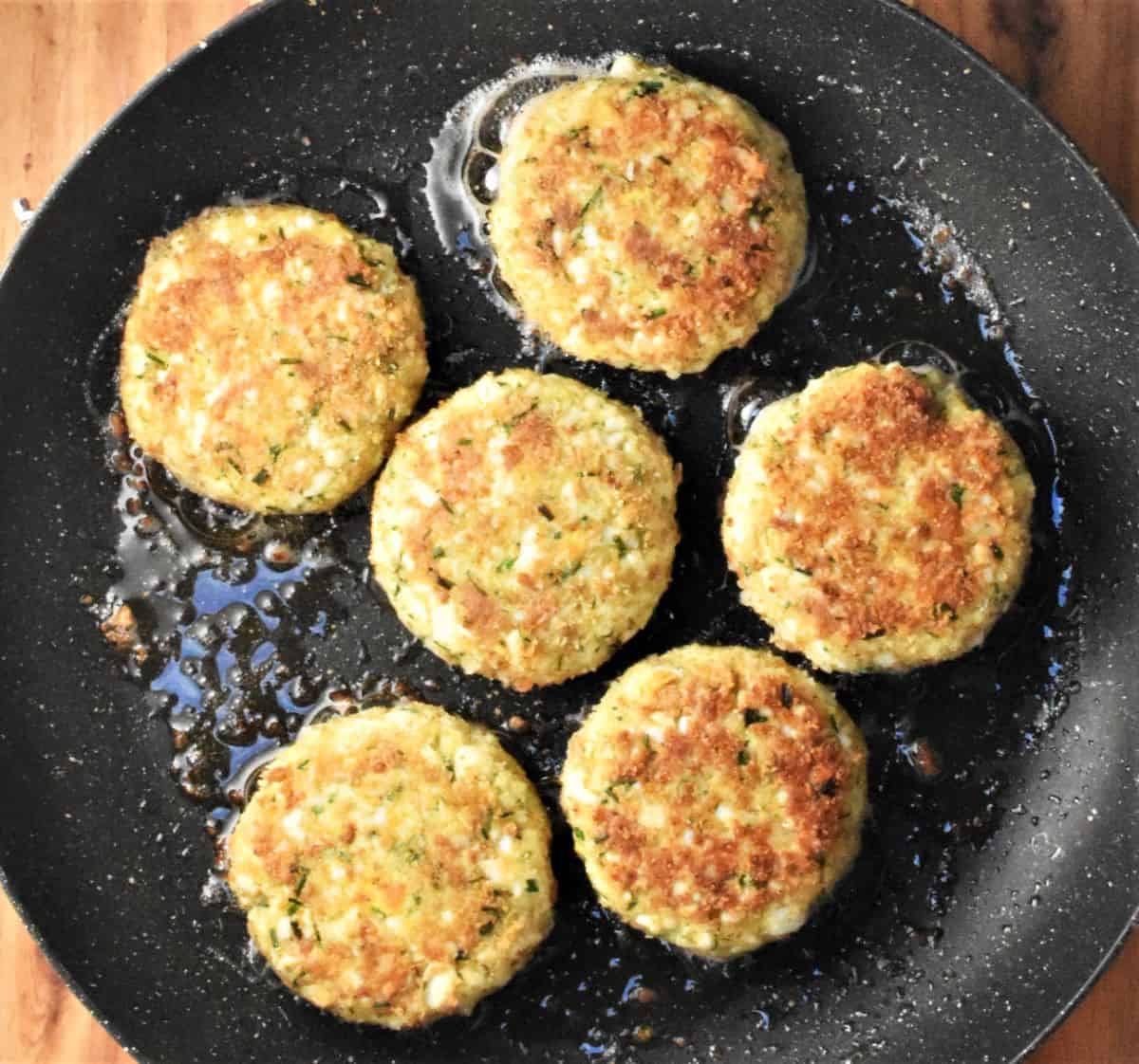 Crispy egg patties in frying pan.