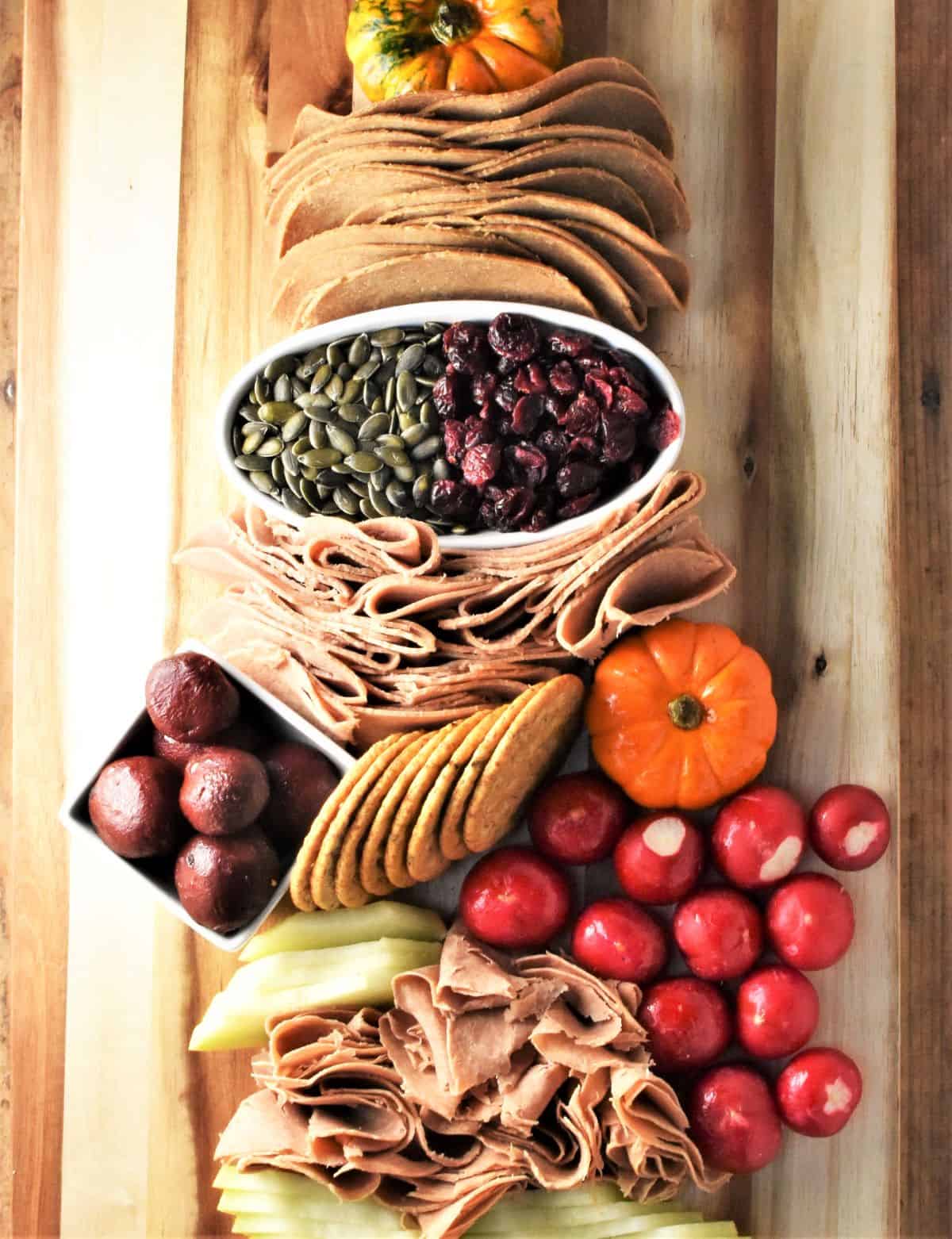 Assembling plant-based charcuterie board.