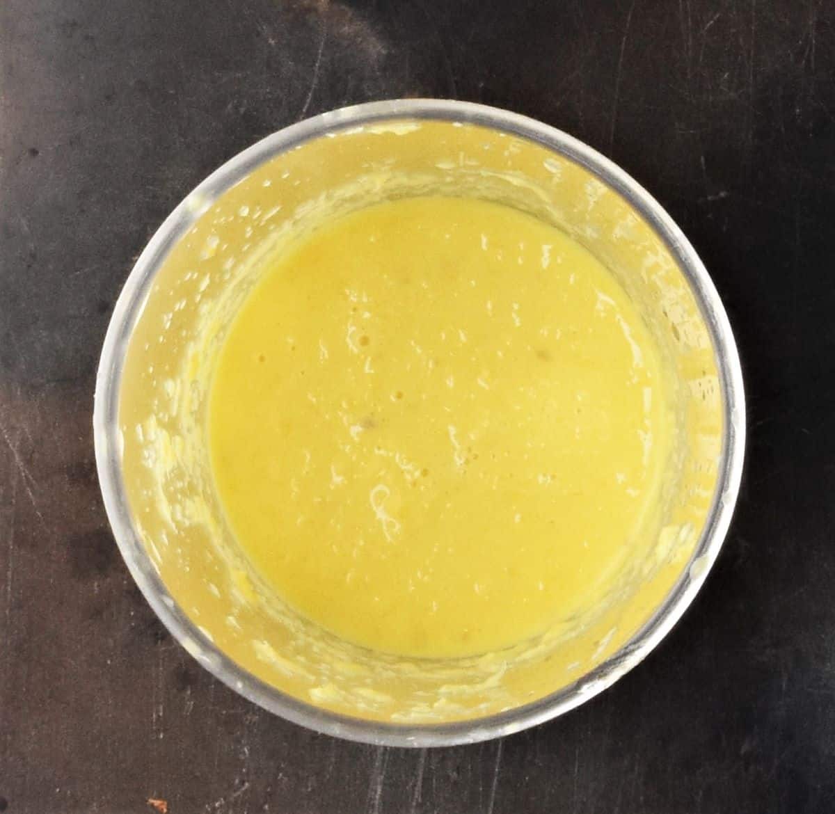 Pureed orange mixture in tall glass.