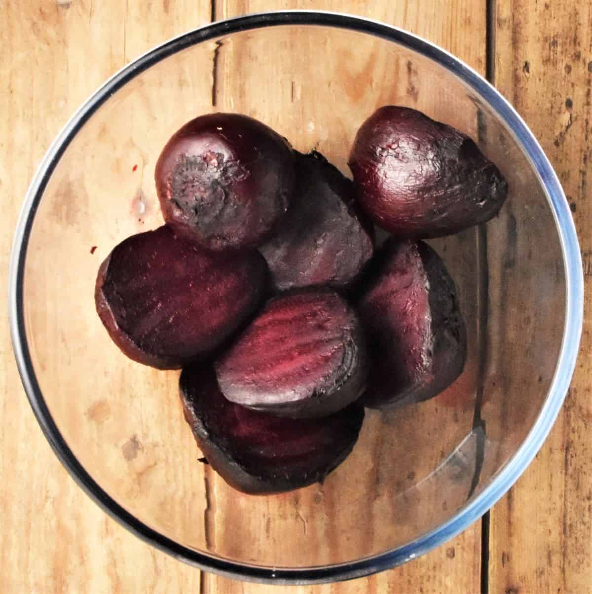 Peeled beetroot in transparent bowl.