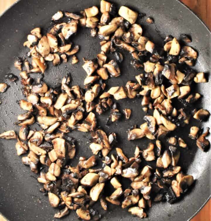 Chopped mushrooms in large shallow pan.