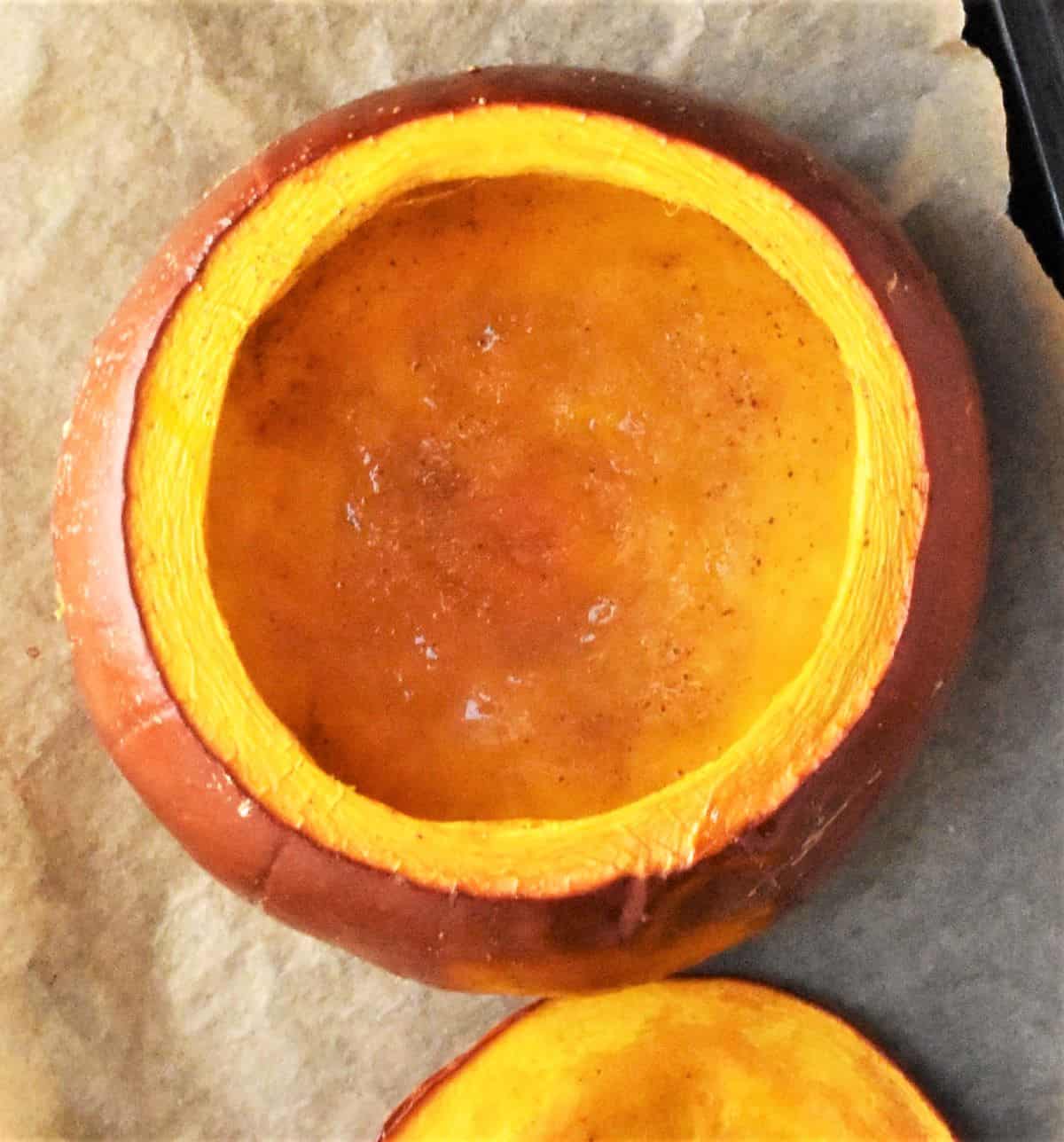 Top down view of hollowed-out raw pumpkin on cutting board.