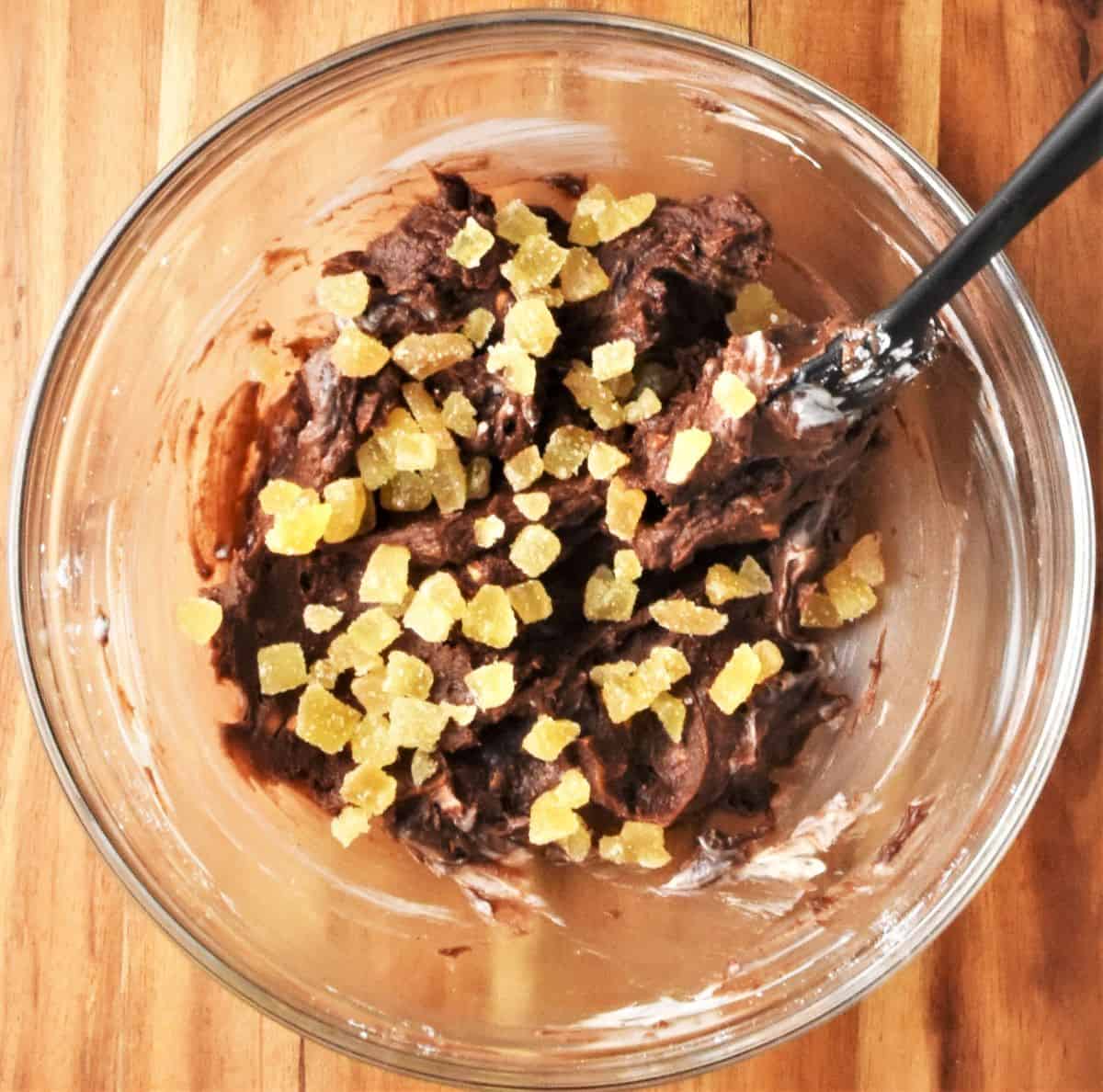 Truffle filling mixture with crystallised ginger in bowl.