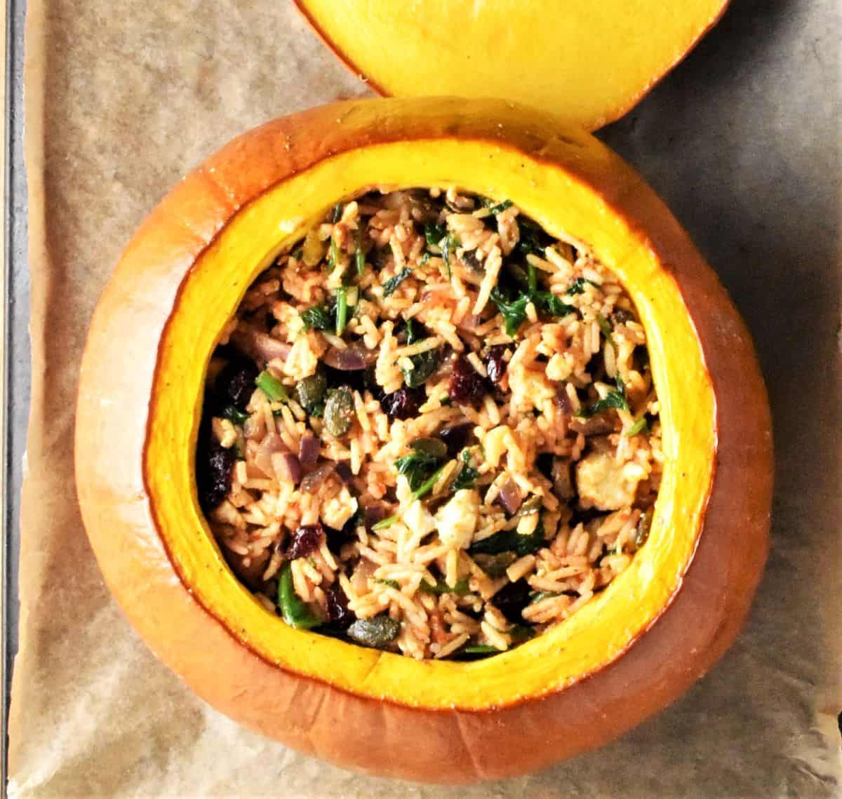 Top down view of rice stuffed pumpkin on parchment.