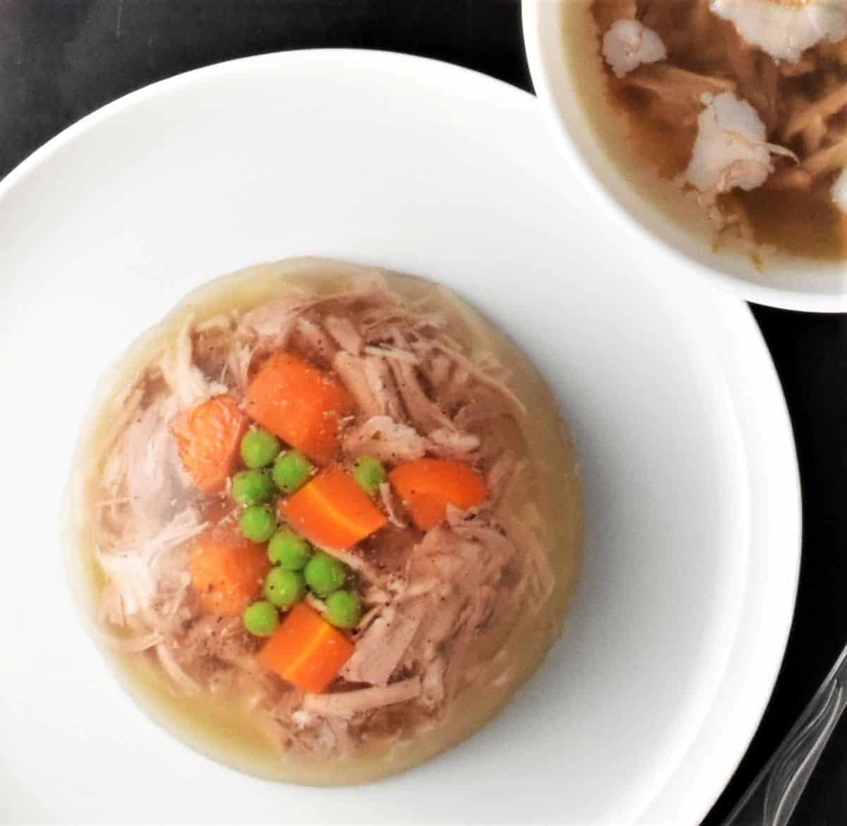 Jellied meat on top of white plate.