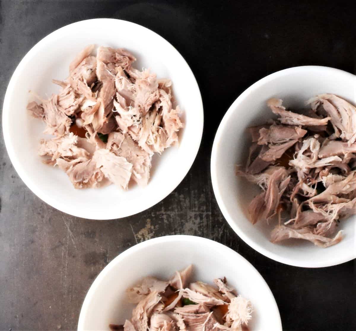 Chopped meat in small white bowls.