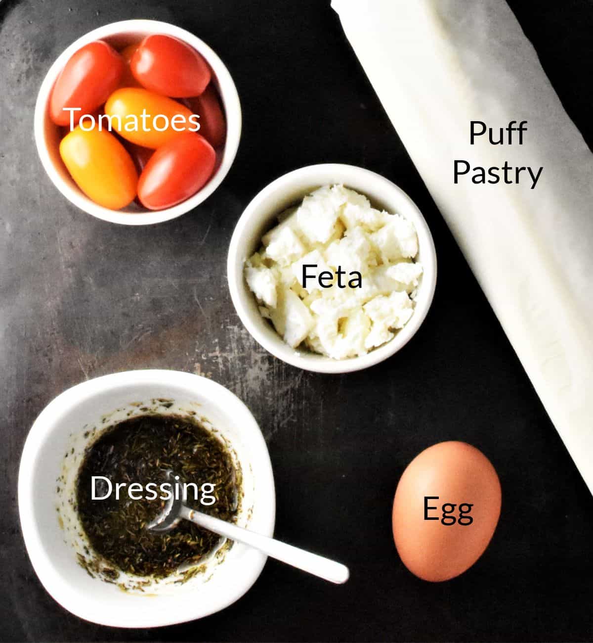 Ingredients for making tomato tartlets in individual dishes.