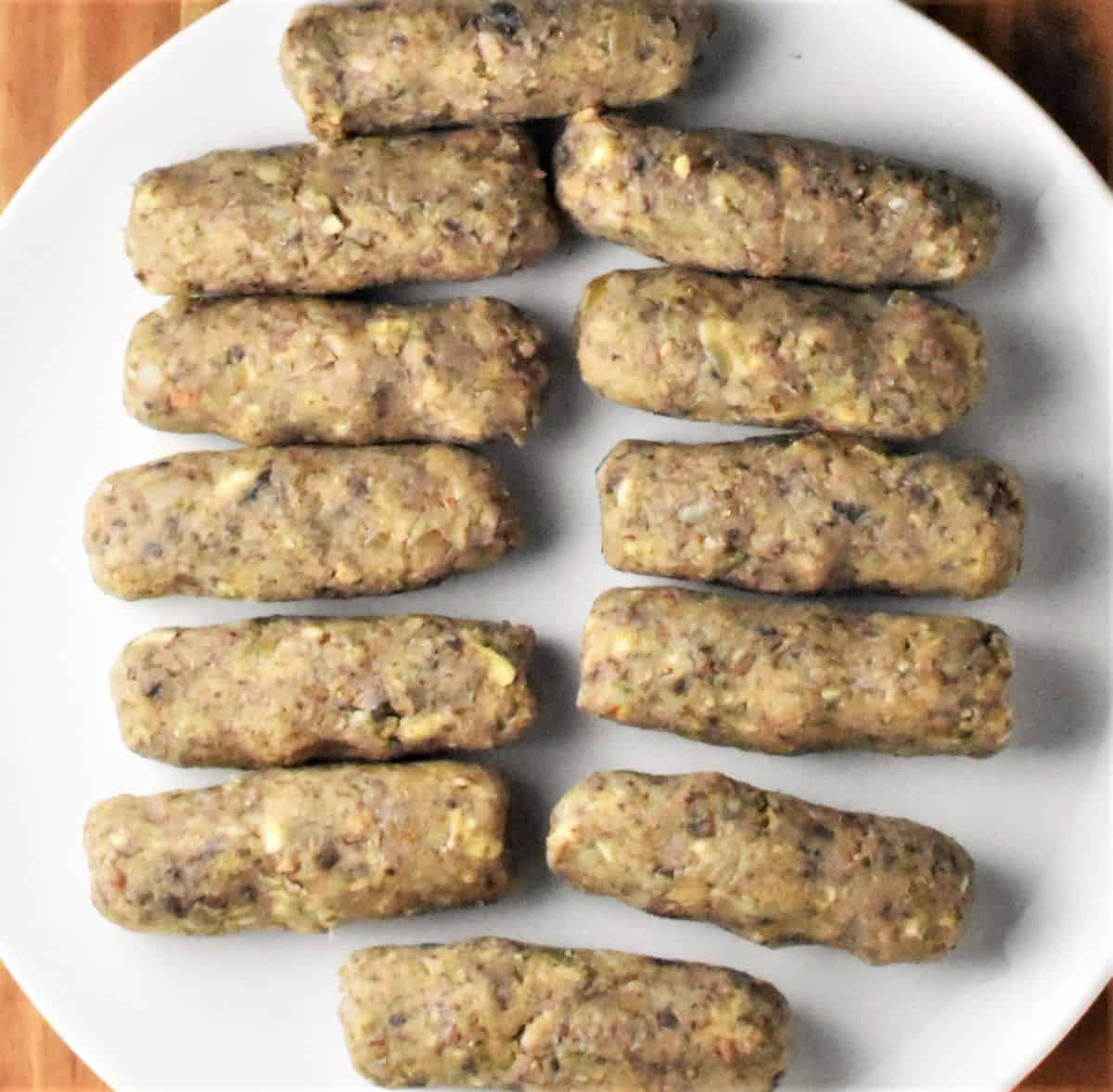 Croquette rolls on top of white plate.