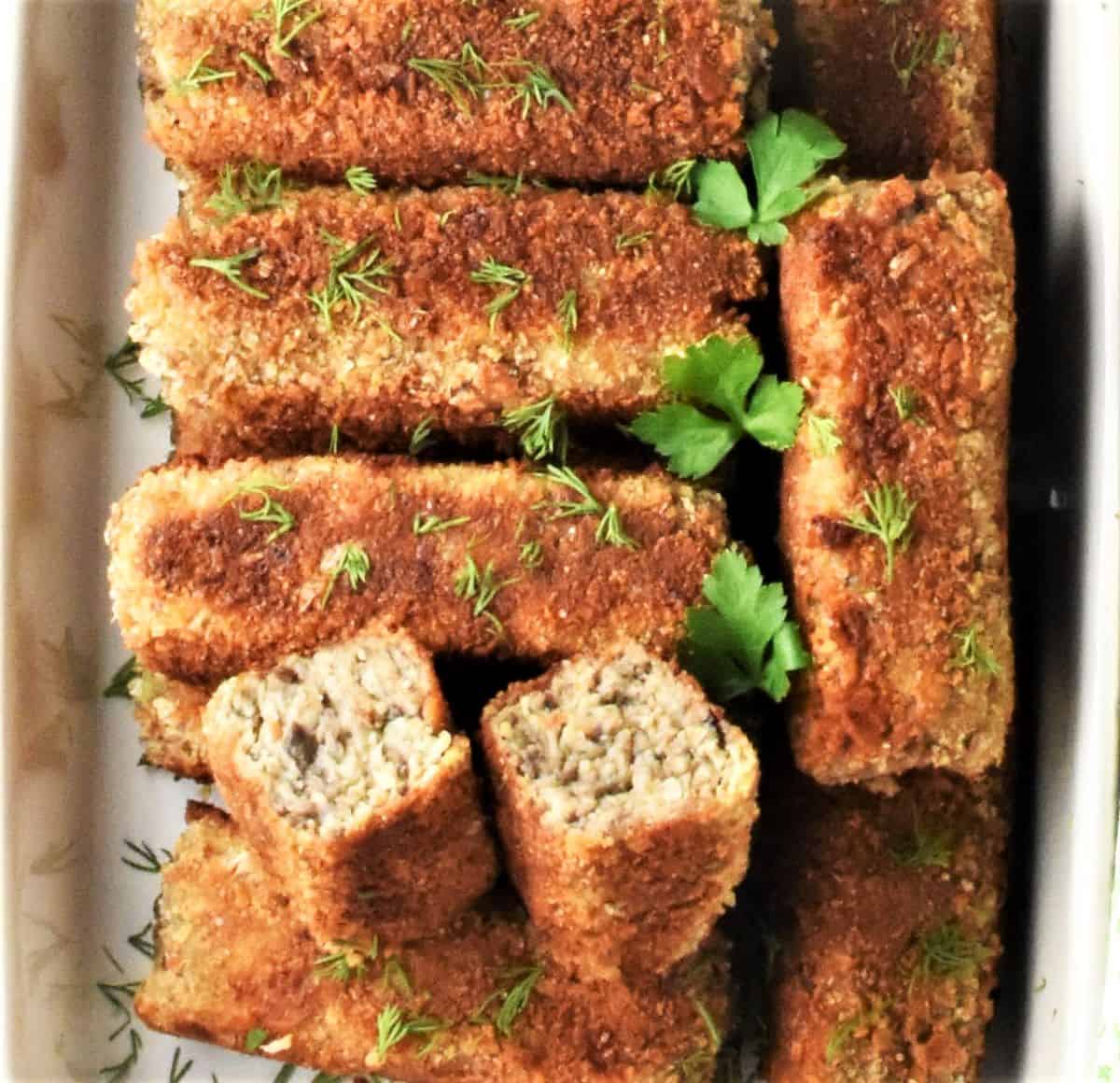 Top down view of Polish mushroom croquettes in ceramic dish.