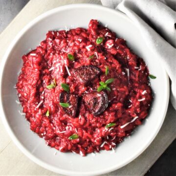 Top down view of beet risotto in grey bowl.