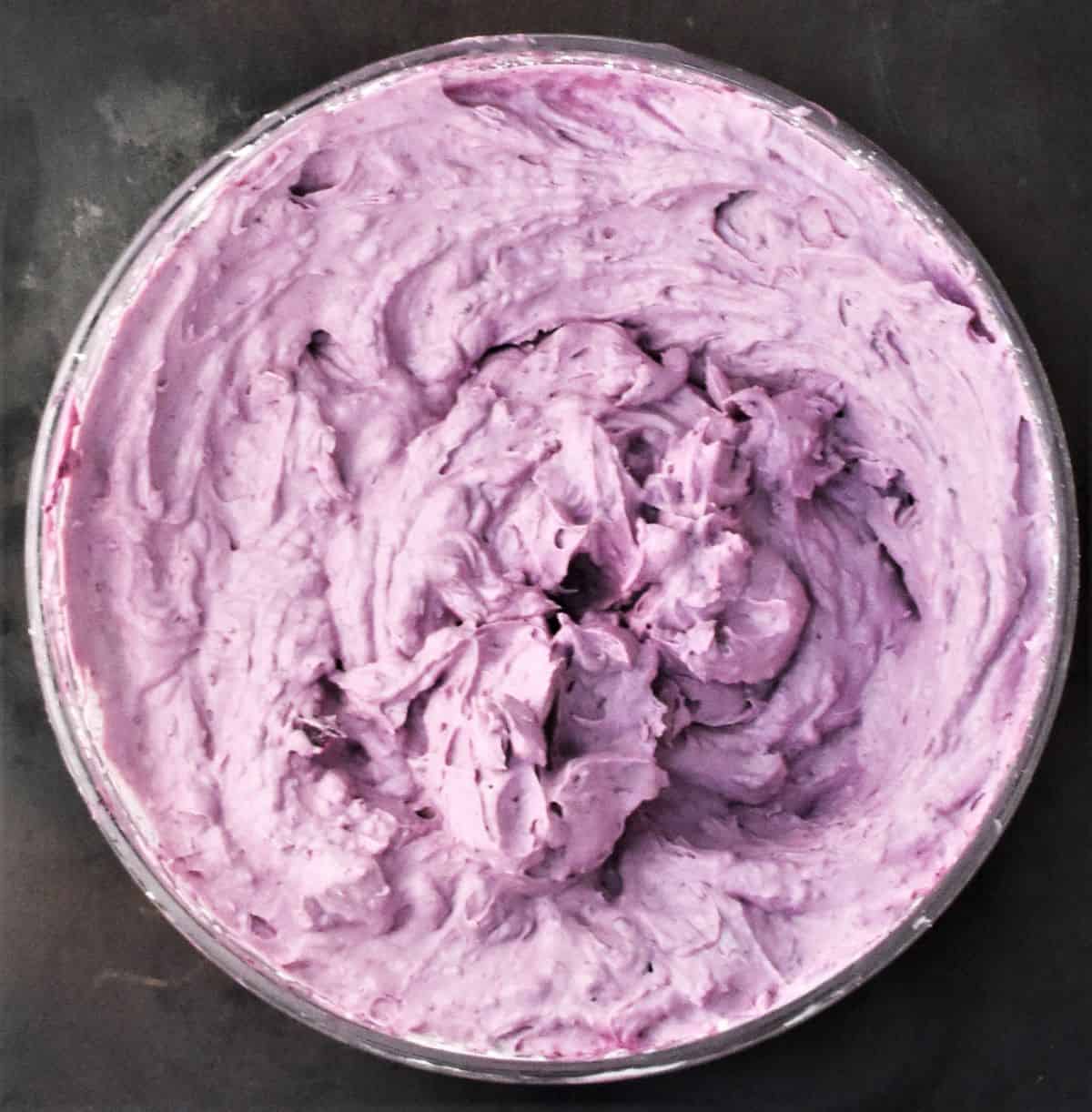 Pink creamy cheesecake mixture in bowl.