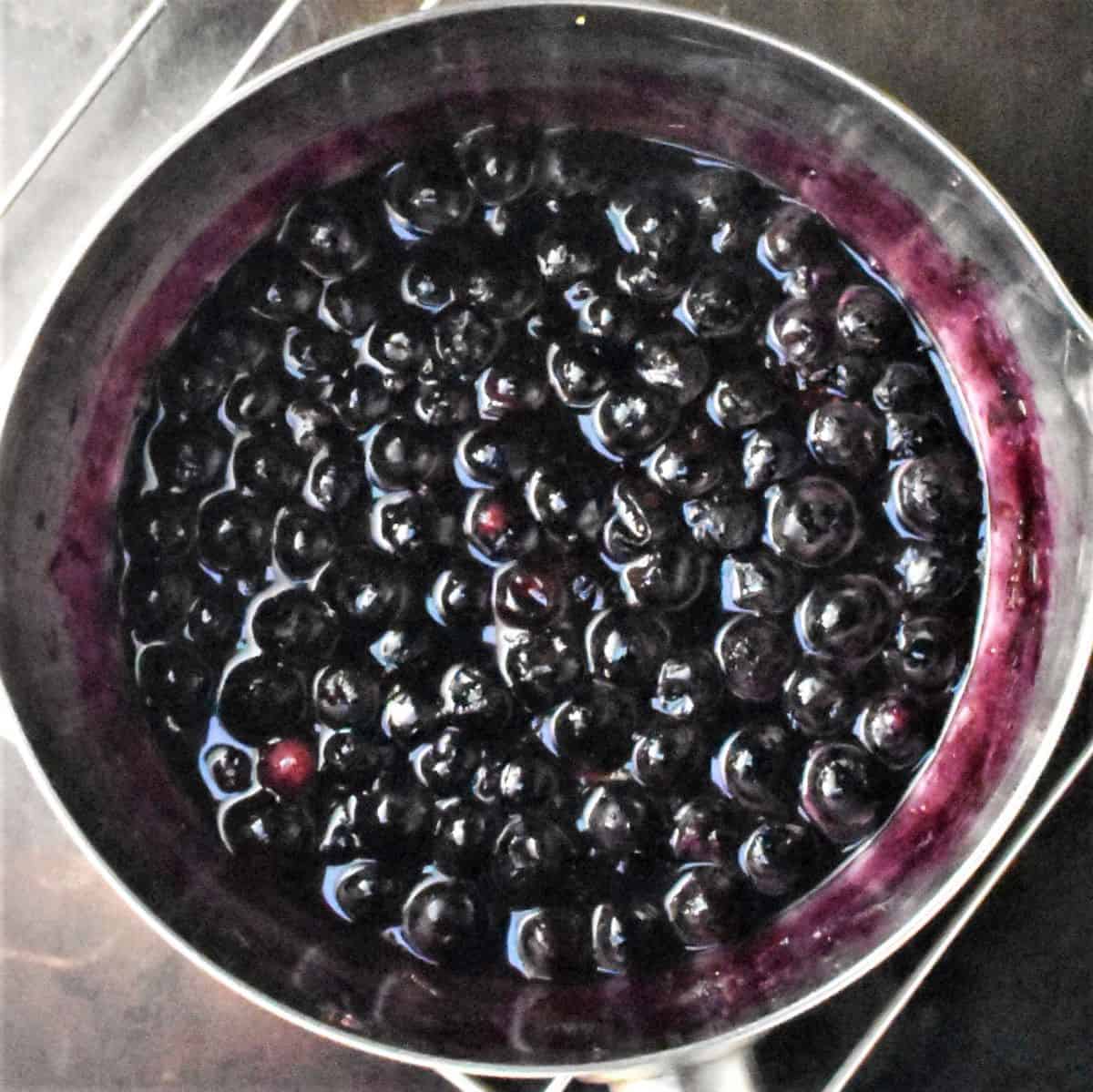 Blueberry sauce in saucepan.