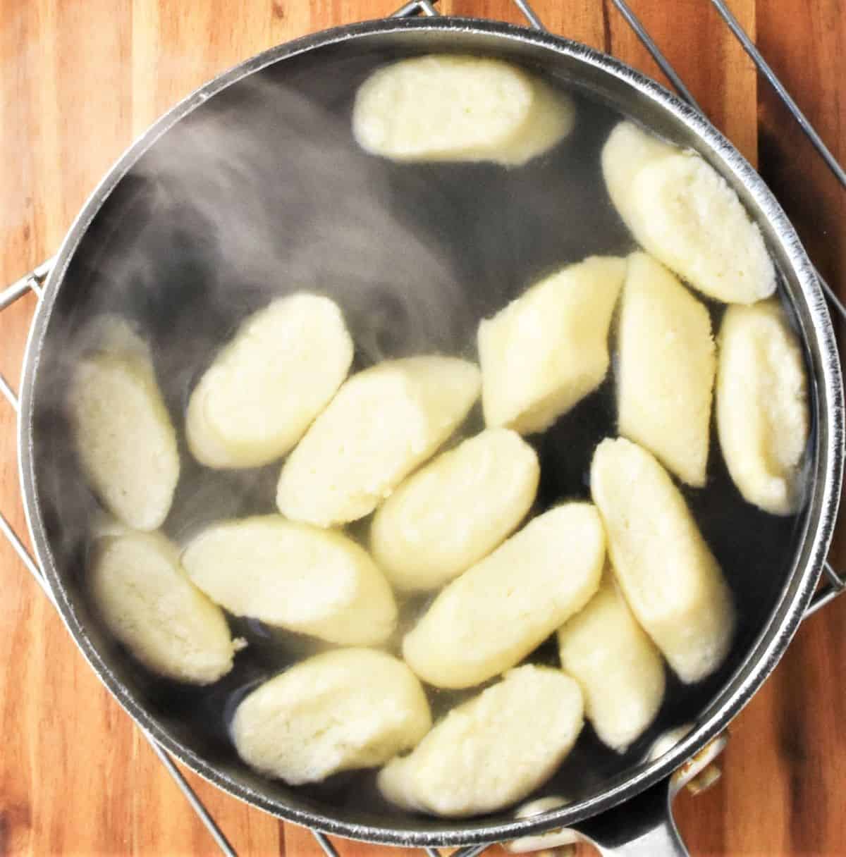 Top down view of cooking lazy pierogi in pot with water.
