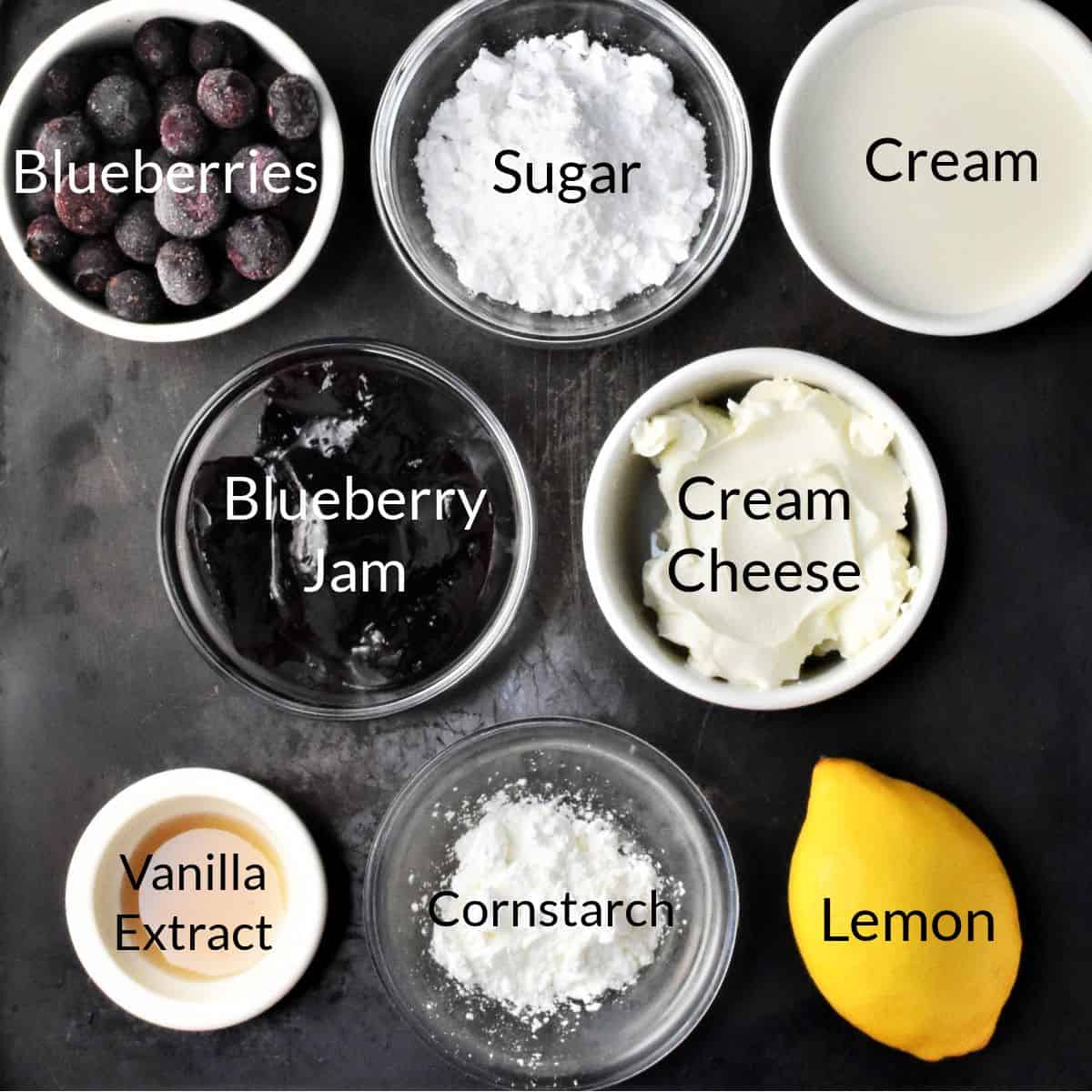 Ingredients for making blueberry no bake cheesecake in individual dishes.