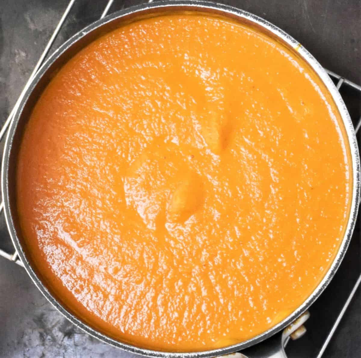 Top down view of creamy soup in pot.