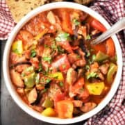 Top down view of Polish letcho in bolw with spoon.