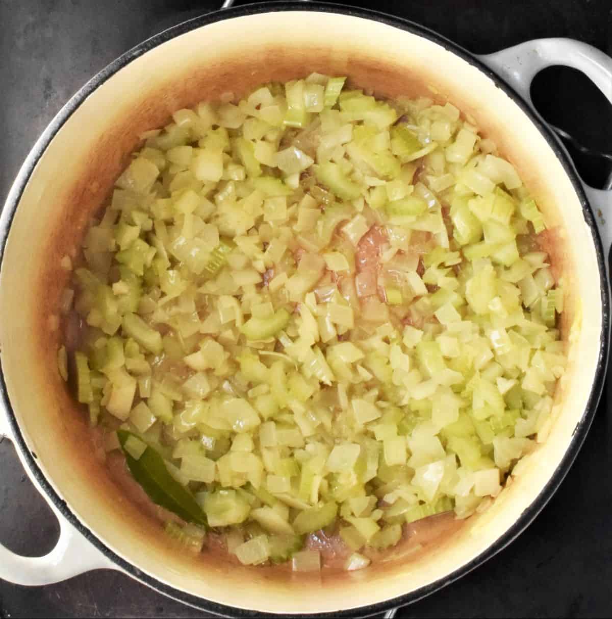 Frying onion in large pot.