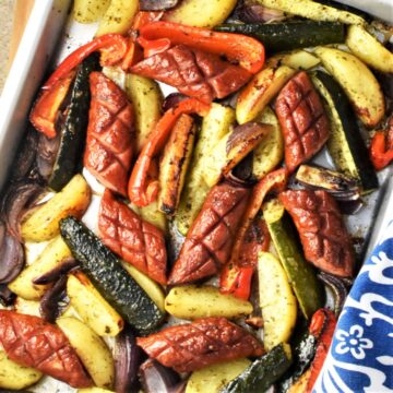 Top down view of baked kielbasa and vegetables.
