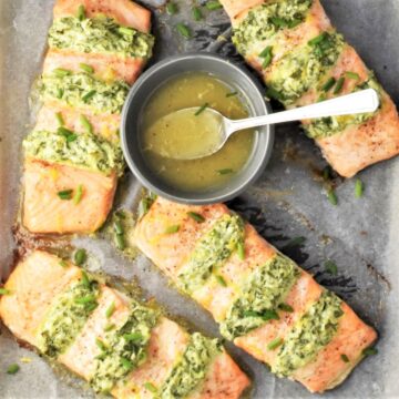 Top down view of hasselback salmon fillets with dressing in bowl.
