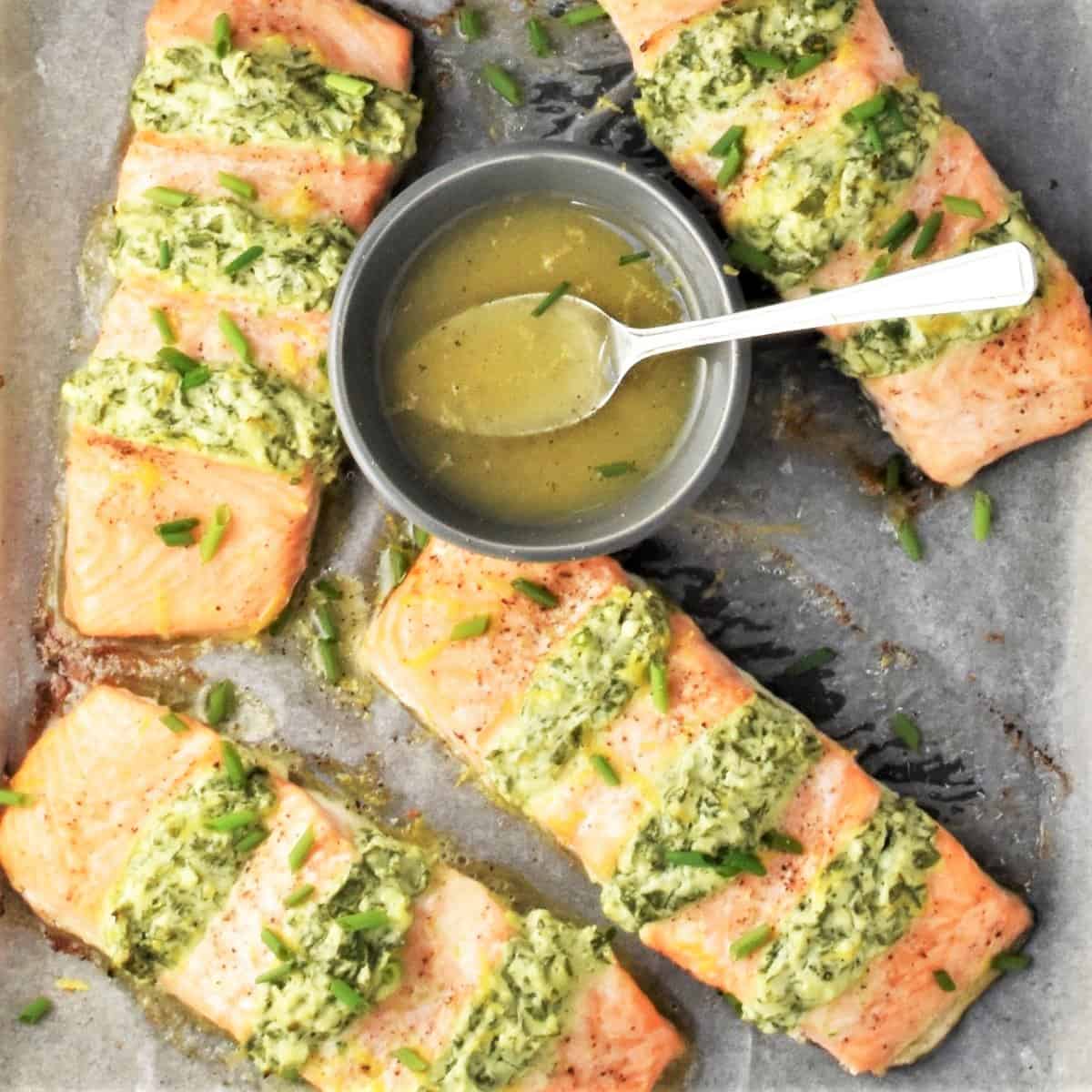 Top down view of hasselback salmon fillets with dressing in bowl.