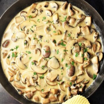 Top down view of mushroom sour cream sauce in large shallow pan.