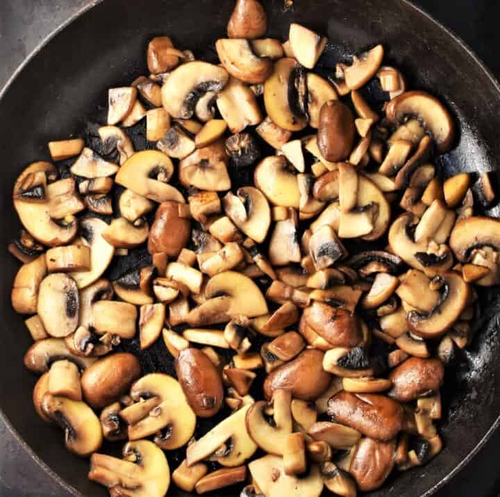Chopped, lightly browned mushrooms in large pan.