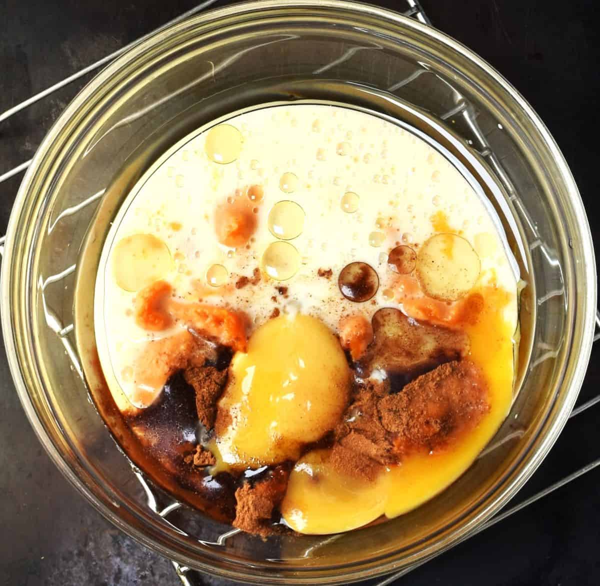 Wet ingredients for making healthy pumpkin pancakes in bowl.