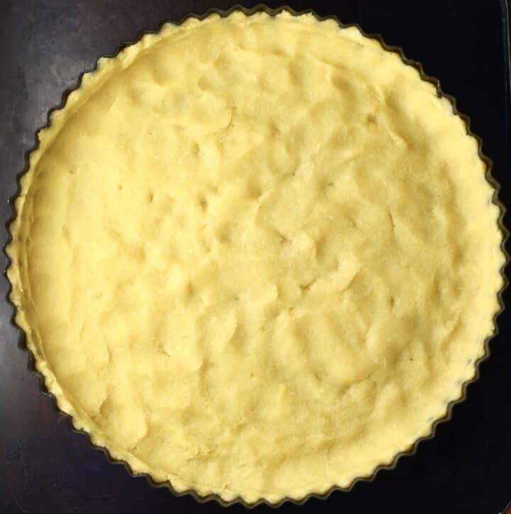 Tart pan lined with pastry.