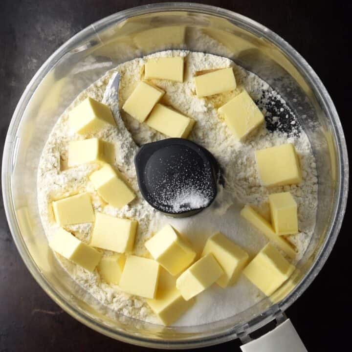 Flour and cubed butter in food processor.