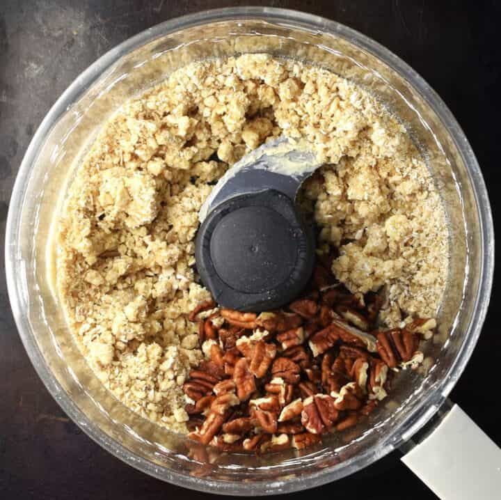 Crumble topping mixture with pecan in food processor.