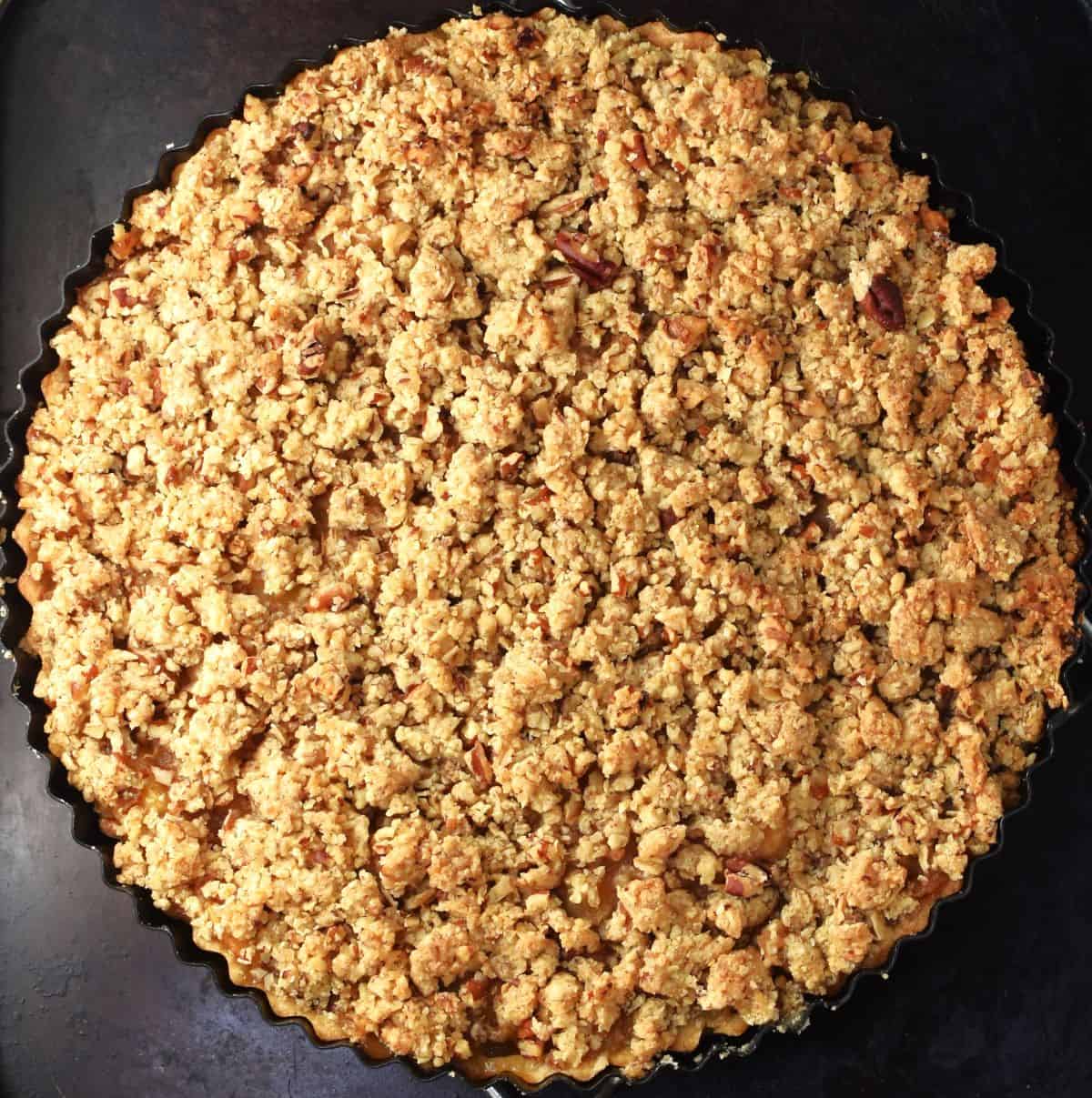 Top down view of baked apple crumb tart.