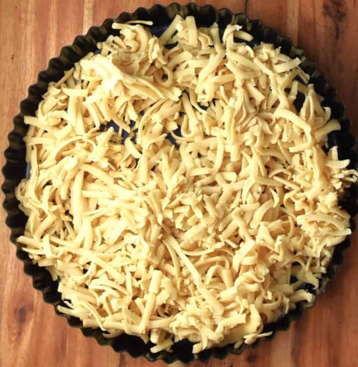 Top down view of grated dough in tart pan.