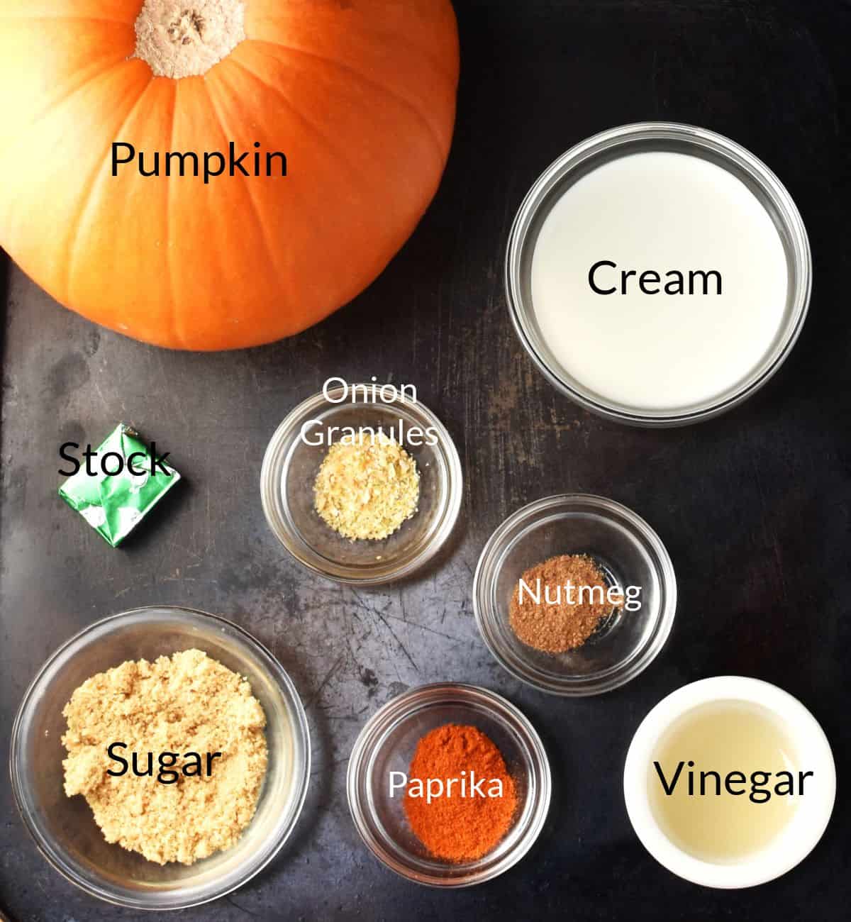 Top down view of ingredients for making Polish pumpkin soup in individual dishes.