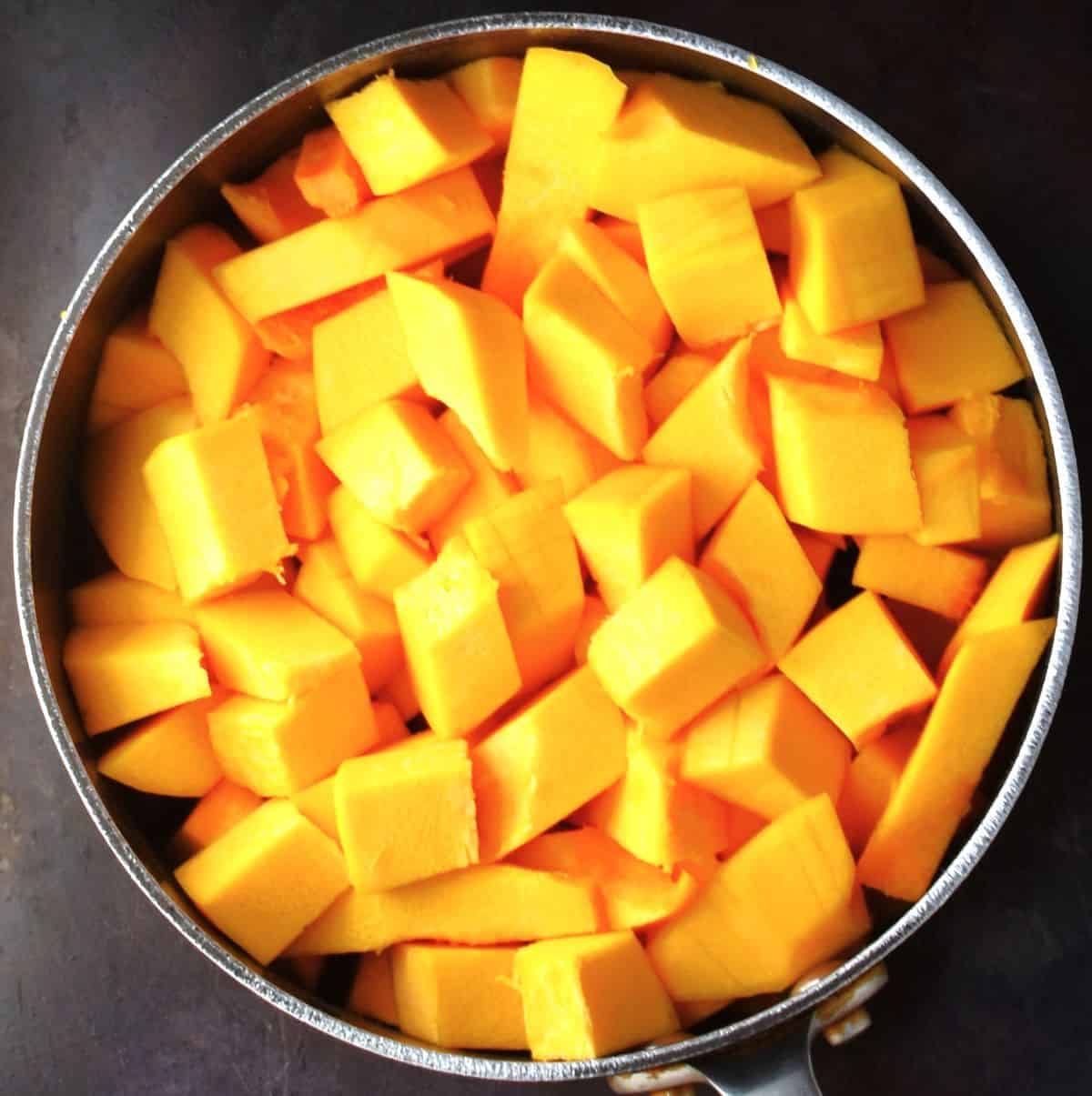 Cubed pumpkin in large pot.