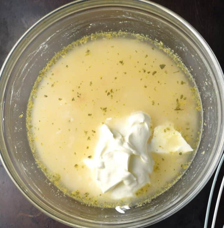 Top down view of stock with sour cream in bowl.