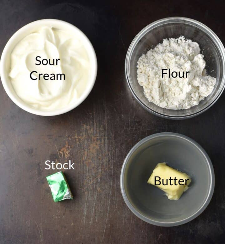 Ingredients for making sour cream sauce in individual dishes.