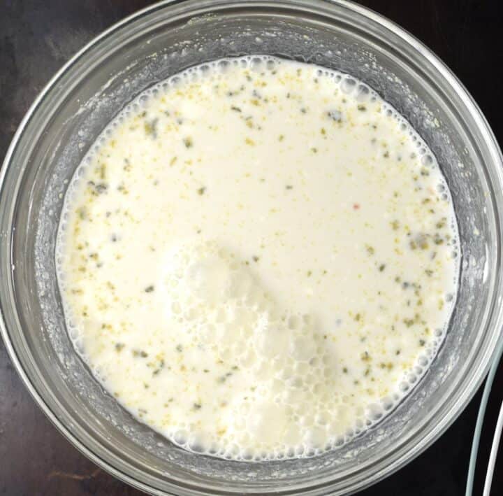 Top down view of sour cream sauce mixture in bowl.