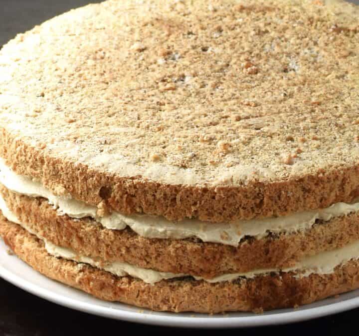 Side view of layered walnut cake.