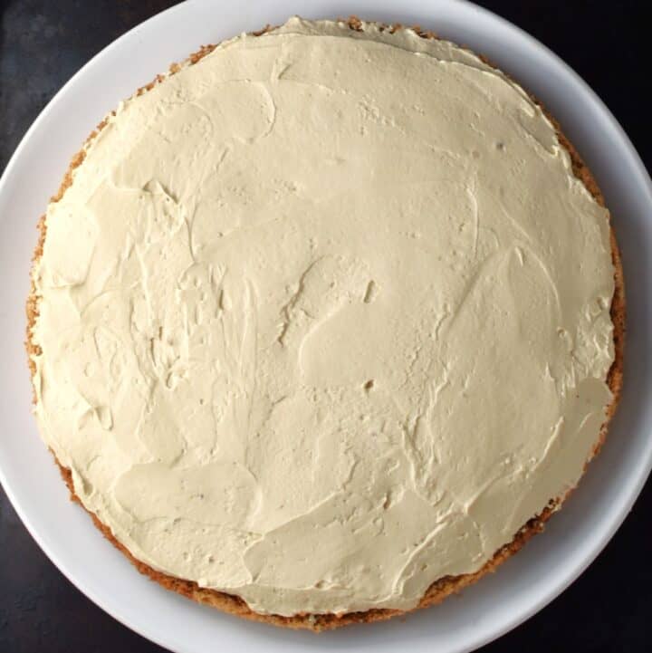 Layering torte with frosting.