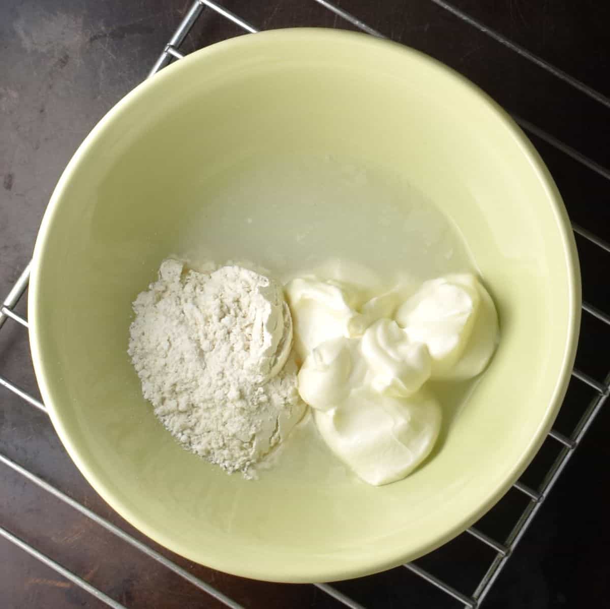 Flour and cream in yellow bowl.