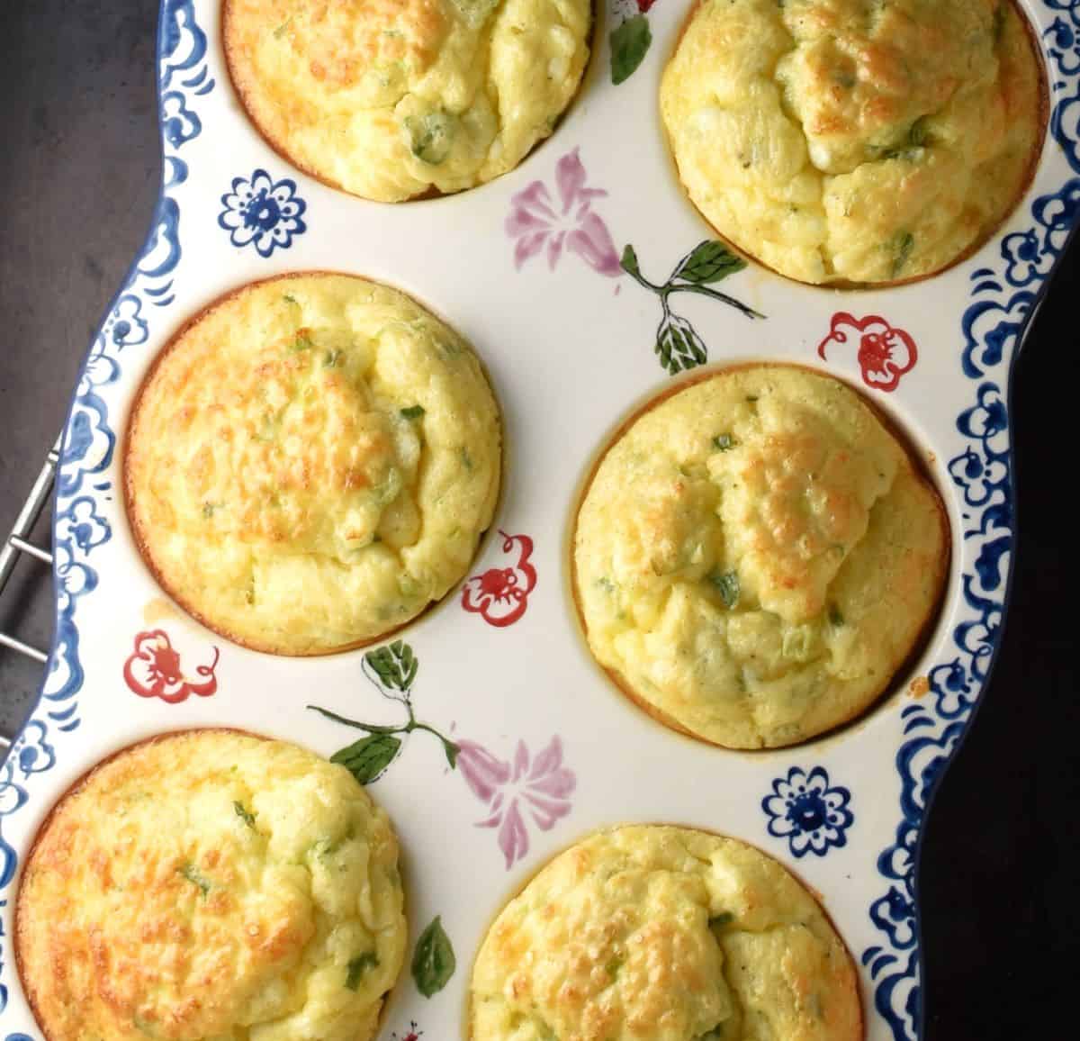 6 baked cottage cheese egg muffins in ceramic muffin pan.