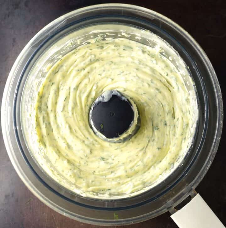 Top down view of creamy dill mayo in food processor bowl.
