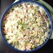 Top down view of Olivier salad in blue bowl.