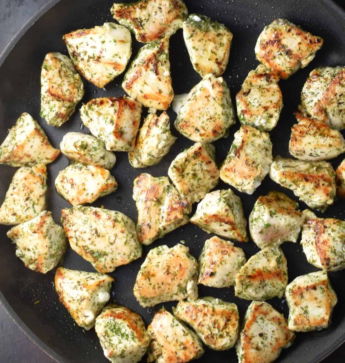 Lightly browned herbed chicken pieces in large pan.