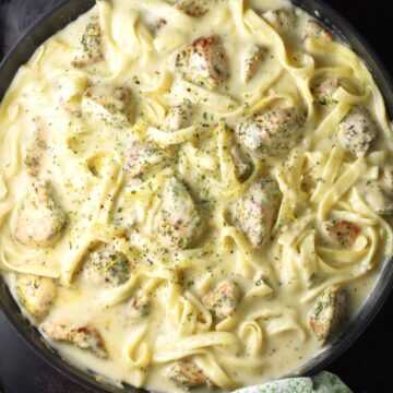 Top down view of sour cream chicken pasta in round pan.