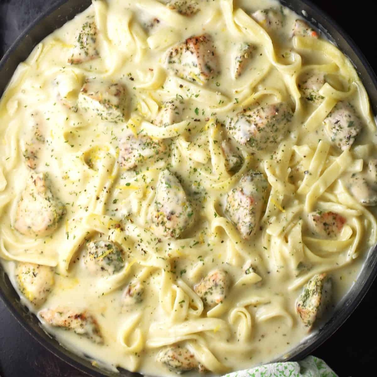 Top down view of sour cream chicken pasta in round pan.