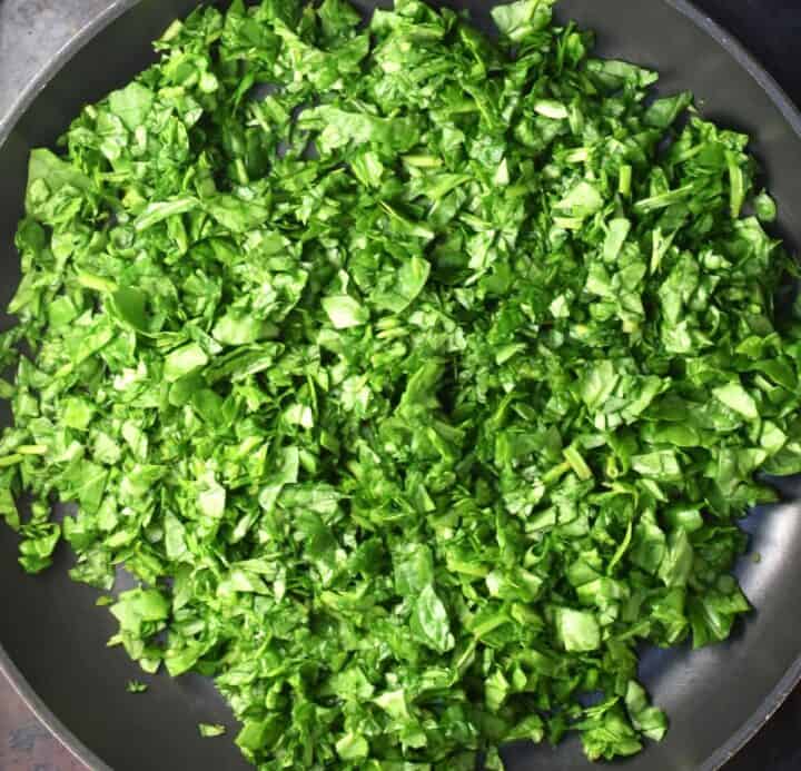 Chopped fresh spinach in pan.