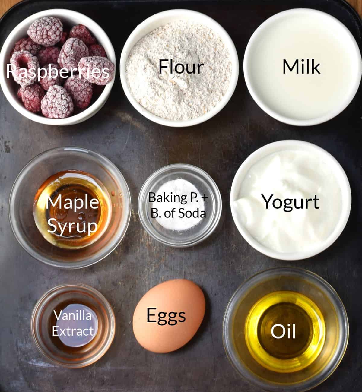 Ingredients for making raspberry pancakes in individual dishes.