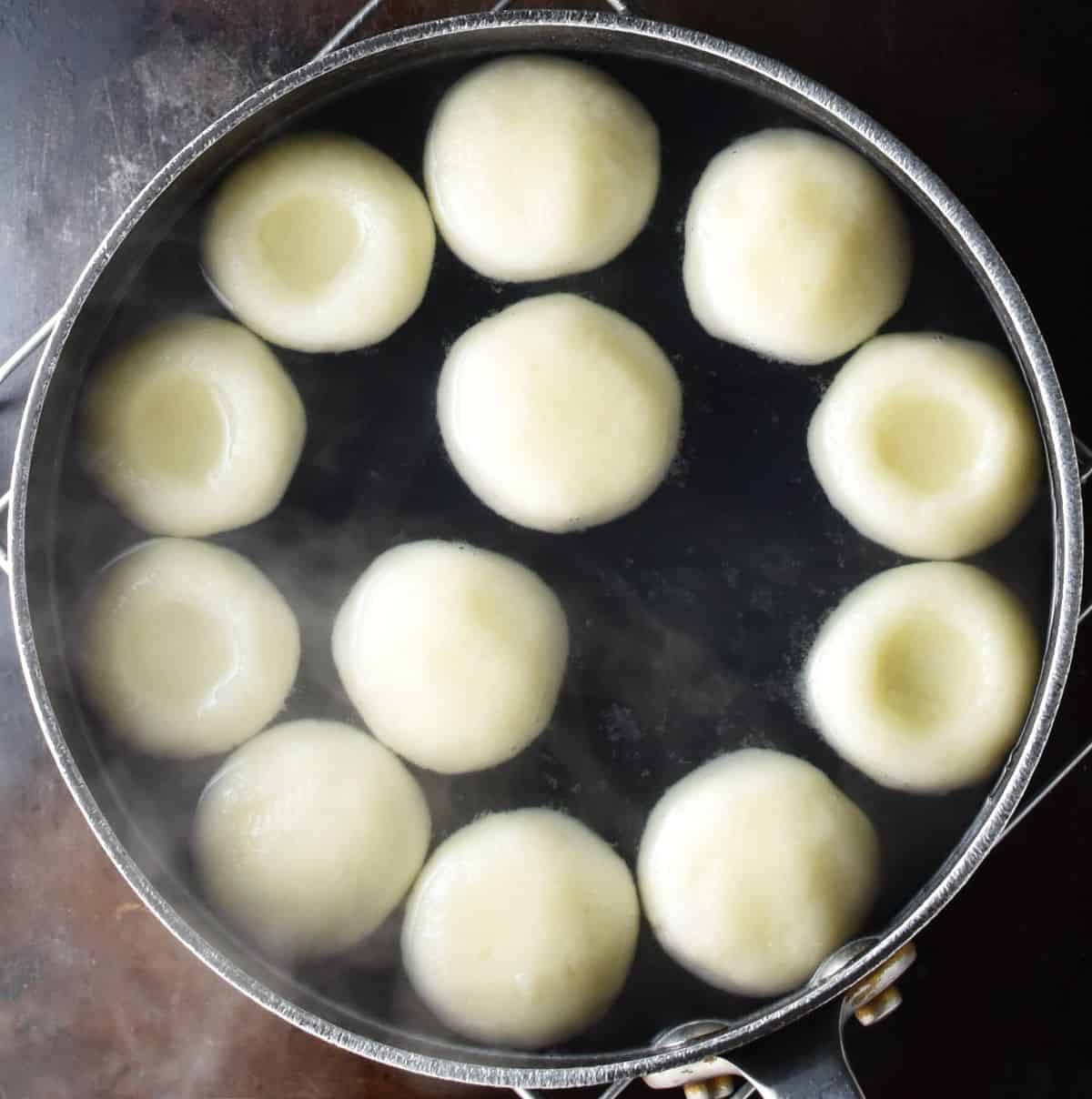 Silesian kluski in pot with water.